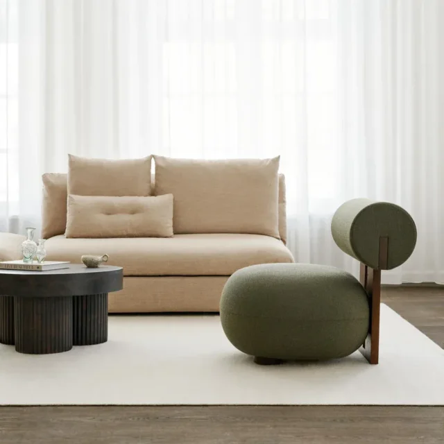 Modern cream single sofa chair with wooden frame, perfect for a cozy living room.