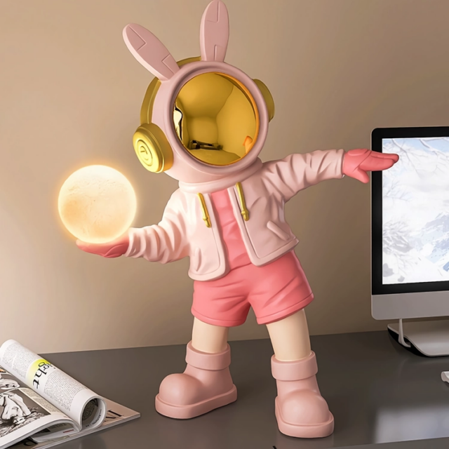 Astronaut-themed resin night light with LED soft glow, ideal for space-inspired decor.