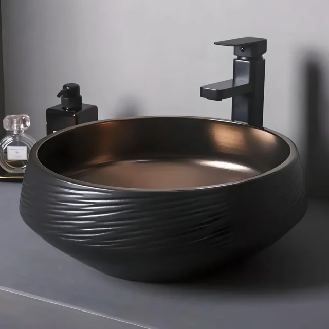 Luxury black and bronze ceramic sink set with a modern dual-tone finish, ideal for contemporary bathrooms.